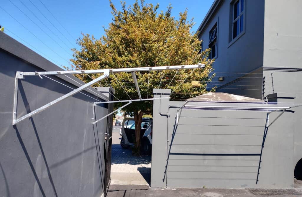 A metal clothesline hanging from a wall.